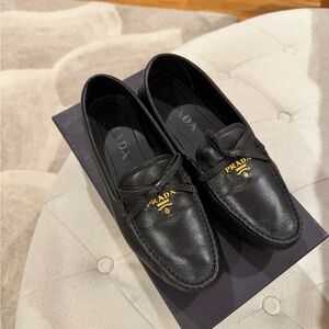 Prada Women's Elegant Black Loafers with Gold Accents